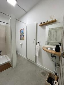 a bathroom with a sink and a mirror at Therma Pilgrim Hostel in Caldas de Reis