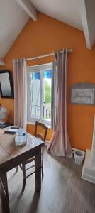 a living room with a table and a window at Les Chambres De Martine Et Guy - in Sermaise +27 photos