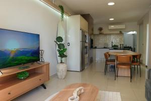 a living room with a large flat screen tv at Casa Beverly, com Piscina, 3 Quartos e Churrasqueira in Foz do Iguaçu