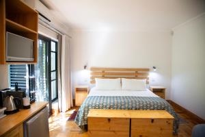a bedroom with a bed and a tv and a bed sidx sidx sidx at 7 Ackermann Place Guest House in Stellenbosch +15 photos