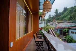 a balcony with chairs and a view of a mountain at Savor Hostel-Motorbike Rental-Tour in Làng Lap