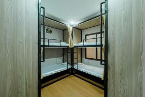 a couple of bunk beds in a room at Savor Hostel-Motorbike Rental-Tour in Làng Lap