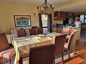 a dining room with a table and chairs at Ol Pejeta Villa in Nanyuki