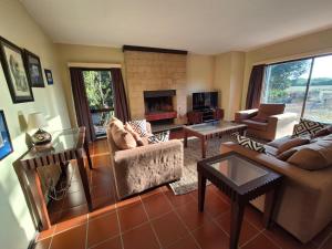 a living room filled with furniture and a fireplace at Ol Pejeta Villa in Nanyuki