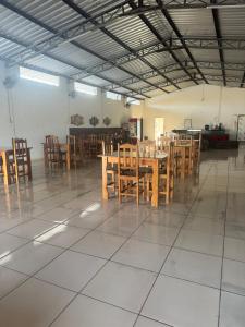 a dining room with wooden tables and chairs at Pousada do Delta in Tutóia