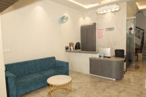 a living room with a couch and a table at Anusha Hotel in Nashik