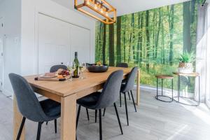a dining room with a wooden table and chairs at Le Taiga - Pool Table Nature Pet Friendly in Pont-Rouge
