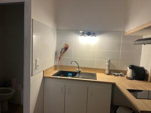 a kitchen with a sink and a counter top at Bleu Mandarou in Millau