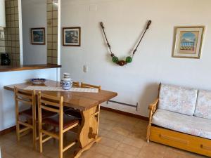a kitchen with a wooden table and a chair at Apartamento Platja Mar 2 in L'Escala