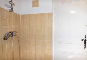 a bathroom with a shower and a white door at Duplex in Grosseto-Prugna +13 photos