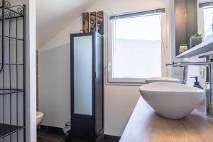 a bathroom with a large white sink and a window at Maison neuve proche lac d'Annecy in Saint-Jorioz +25 photos