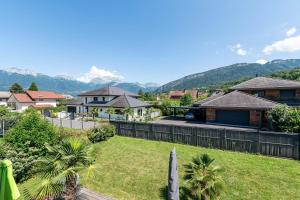a view of a yard with houses and mountains at Maison neuve proche lac d'Annecy in Saint-Jorioz