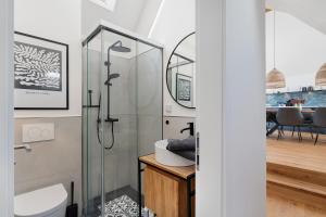 a bathroom with a shower with a toilet and a sink at Das Alte Pfarrhaus - Scheune in Gleisweiler +24 photos