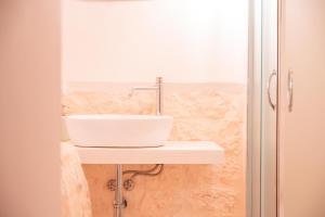 a white sink on a counter in a bathroom at Villa Trullo Vecchia Aia in Alberobello +8 photos