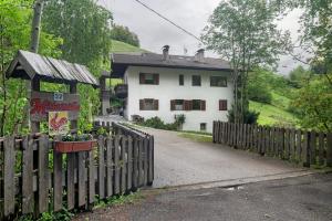 a fence in front of a white house at Mittermüllerhof Feldthurns in Velturno
