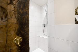 a shower with a glass door in a bathroom at Ferienwohnung Schatztruhe in Maring-Noviand +17 photos