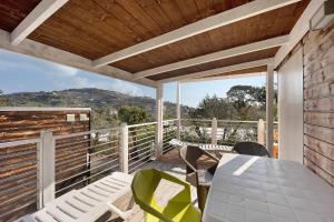 a patio with a table and chairs on a deck at Mobile Home Next 229 in Pietra Ligure