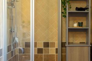 a bathroom with a shower with a glass door at Casa Nuages in Badesi +16 photos