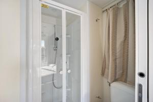 a shower with a glass door in a bathroom at Mobile Home Next 229 in Pietra Ligure +16 photos