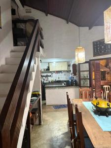 a kitchen and dining room with a table with a bowl on it at Refúgio da Vila in Ilhabela