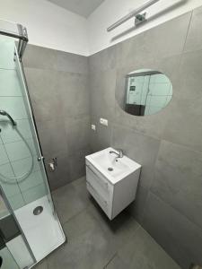 a bathroom with a sink and a mirror at Tatrabyt in Bánovce nad Bebravou