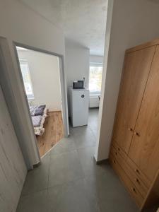 a room with a hallway with a wooden door at Tatrabyt in Bánovce nad Bebravou