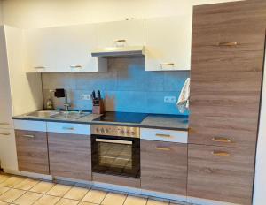 a kitchen with white cabinets and a stove top oven at Ferienwohnung Sonnenschein in Tülau