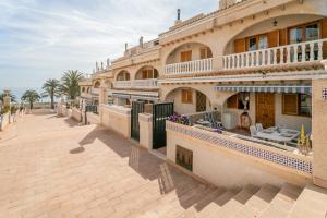 a large building with a walkway in front of it at Playa Arenales del Sol in Arenales del Sol