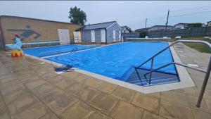 a large swimming pool with aicrobialicrobialicrobial at Seagulls Sunrise in Seasalter