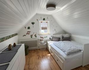 a bedroom with a bed in a attic at Domizil-Kaiserstuhl in Ihringen +24 photos