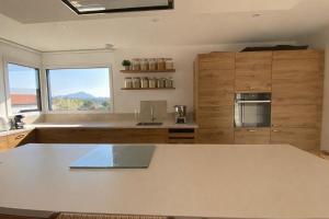 a kitchen with a counter and a large window at L'échappée in Viols-le-Fort