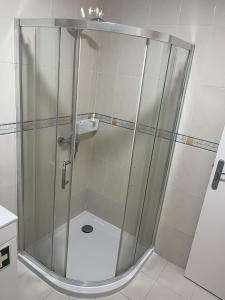 a shower with a glass door in a bathroom at A m a r - 450m from the beach in São Roque +31 photos