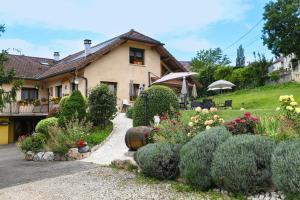 a house with a garden in front of it at L'orée du bois in Yenne