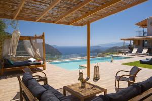 a villa with a view of the pool and the ocean at Modern Country Villa in Lefkada