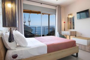 a bedroom with a bed and a balcony with a view at Modern Country Villa in Lefkada +22 photos