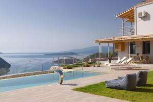 a villa with a swimming pool and a house at Modern Country Villa in Lefkada