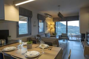 a kitchen and a living room with a table and chairs at Modern Country Villa in Lefkada