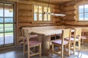 a dining room with a wooden table and chairs at Blockhaus Almhütte Hofblick in Glatten +6 photos