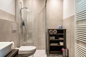 a bathroom with a shower and a toilet and a sink at Mountain Meadows Apt 3 in Valdaora +19 photos
