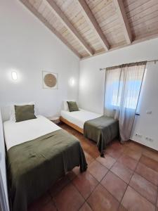 a bedroom with two beds and a window at Paraiso da Serva - Courela da Serva in Odemira +22 photos