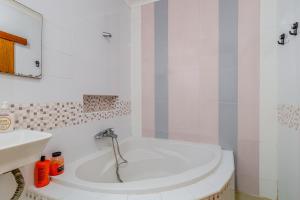a white bathroom with a tub and a sink at Vista Das Estrelas M4 - Terceira in Praia da Vitória +32 photos
