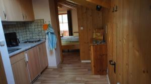 a kitchen with wooden walls and wooden flooring at Ferienwohnung Kramerblick in Grainau