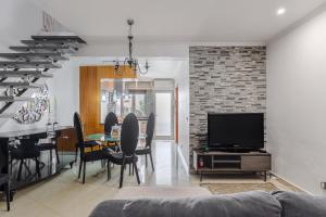 a living room with a television and a dining room at Vista Das Estrelas M4 - Terceira in Praia da Vitória