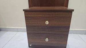 a wooden chest of drawers with two pulls at عمارة دار الضيافة in Medina