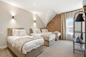 a bedroom with two beds and a window at The Stuart Hotel in Liverpool