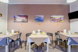 a dining room with two tables and chairs at Paladino in Giardini Naxos