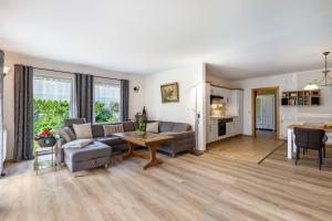 a living room with a couch and a table at Ferienhaus Jasmin in Neuruppin