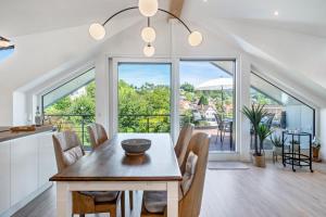 a kitchen and dining room with a table and chairs at Pfänderblick in Lindau