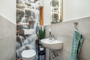 a bathroom with a sink and a toilet at Pfänderblick in Lindau +14 photos