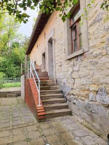 a stone building with stairs leading up to a window at Schöne Wohnung Landhaus-Flair in Aachen